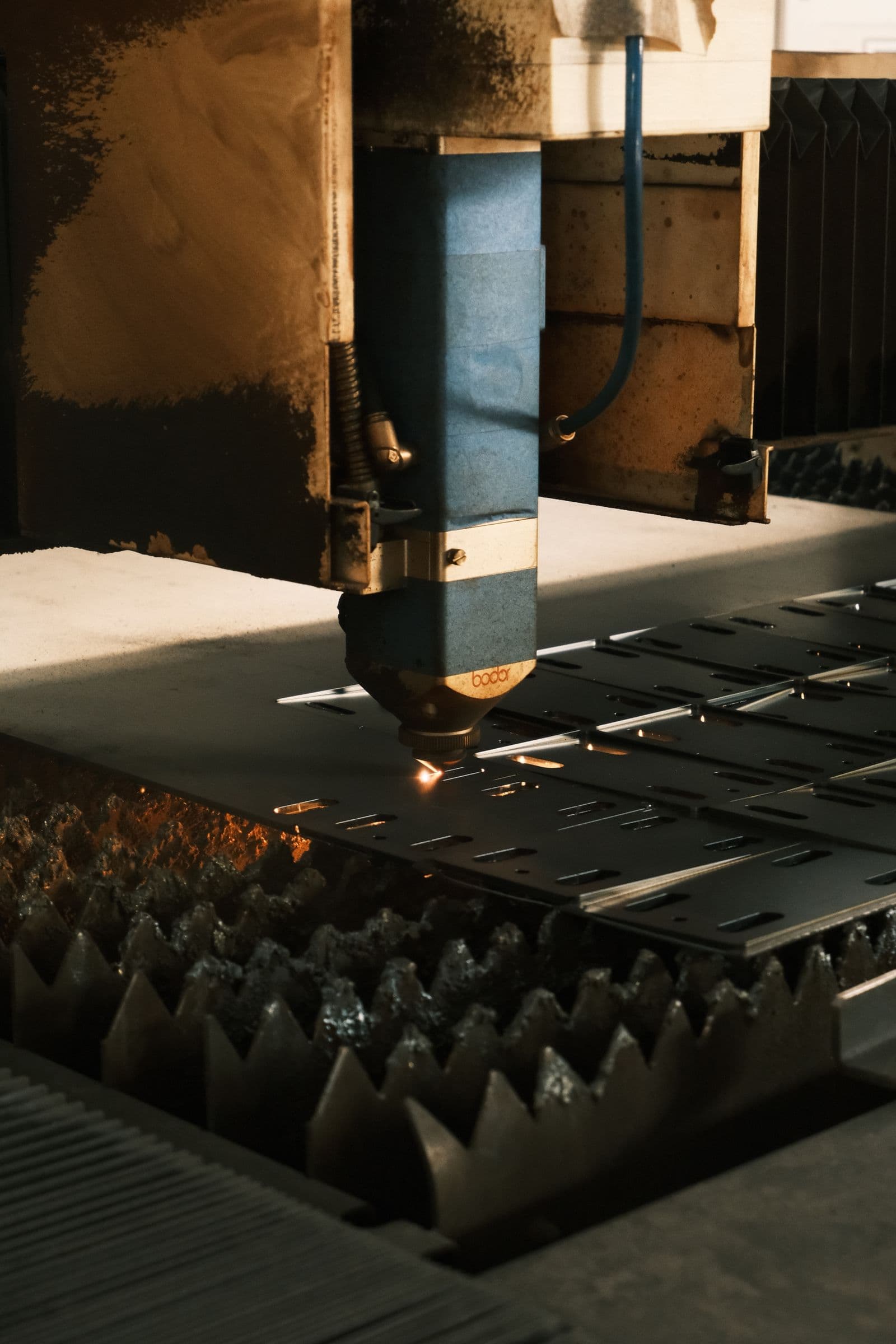A laser cutting a steel sheet
