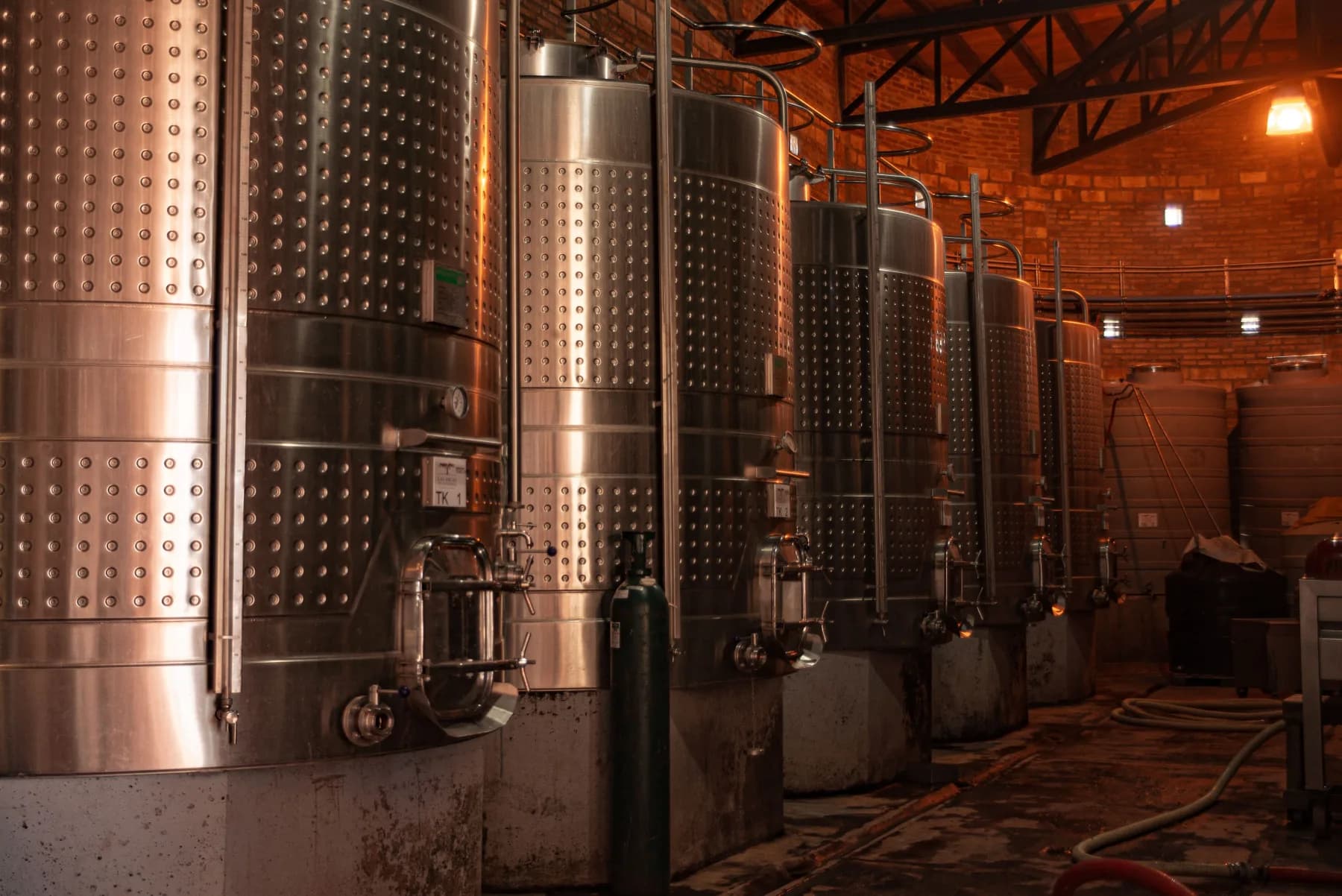 Large industrial production plant with a row of stainless-steel process tanks