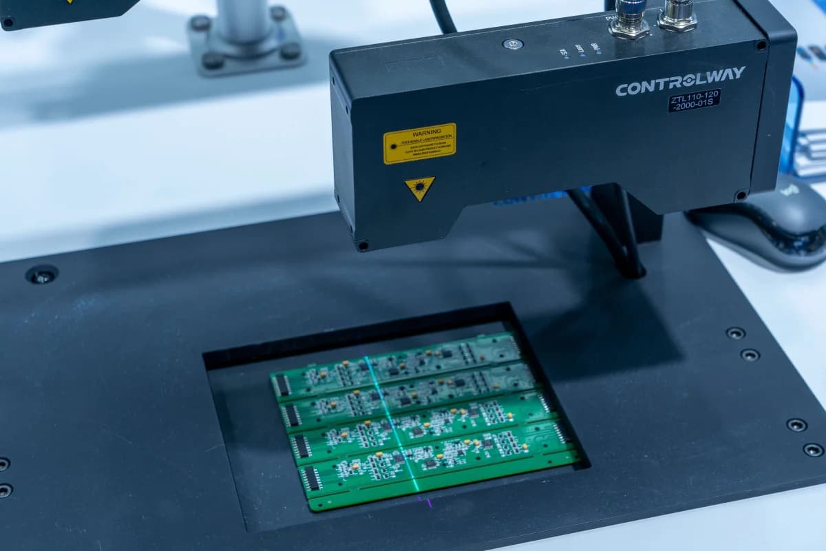 Automated inspection equipment scanning populated printed circuit boards