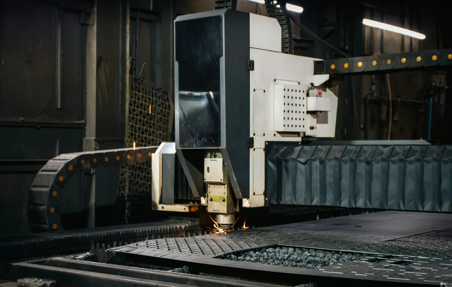 Industrial laser cutting machine processing a sheet of metal in Mumbai, India
