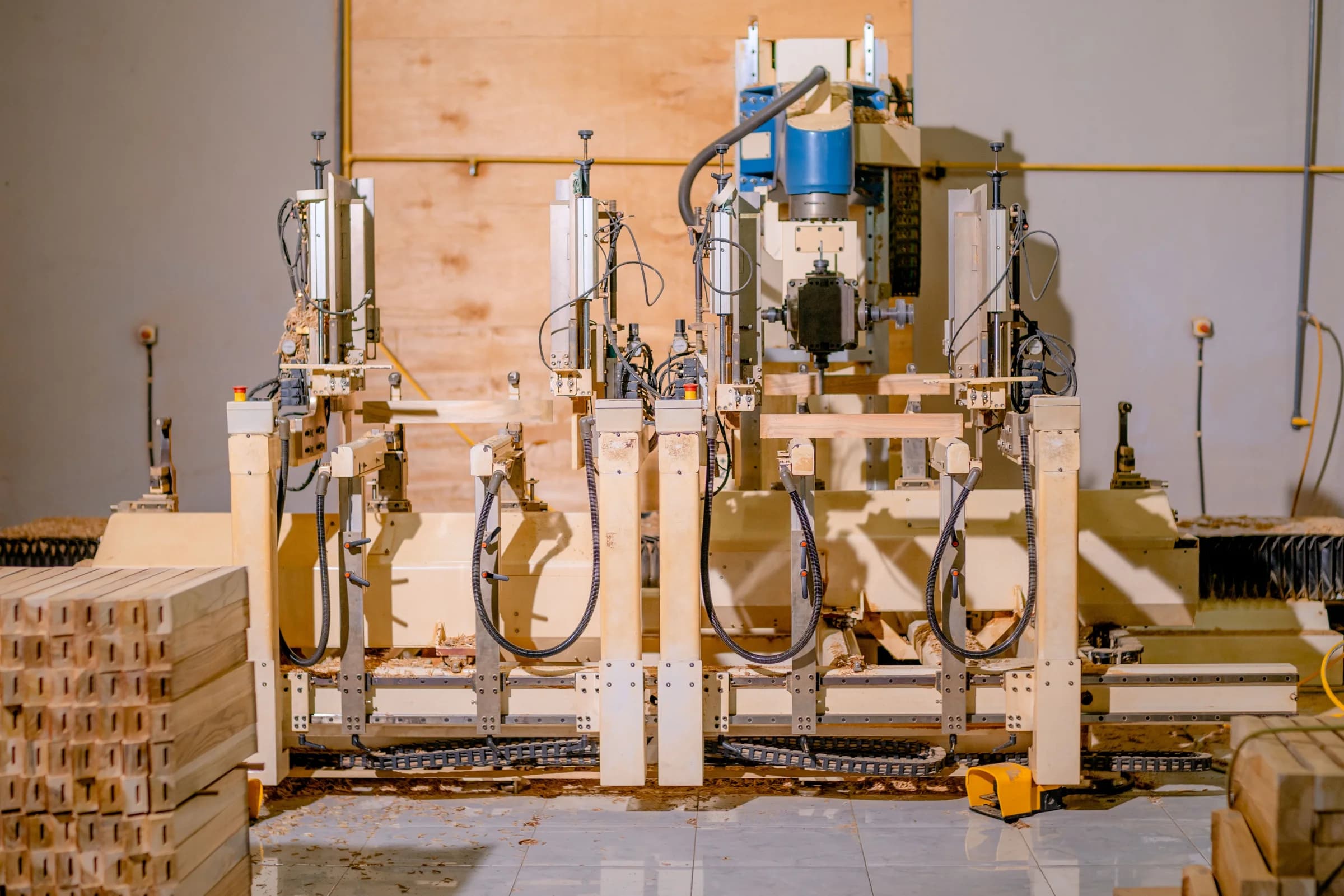 Large automated woodworking machine on a furniture factory floor