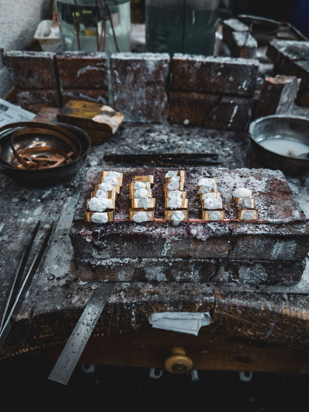 Jewellery metal pieces arranged in separate groups on a working bench