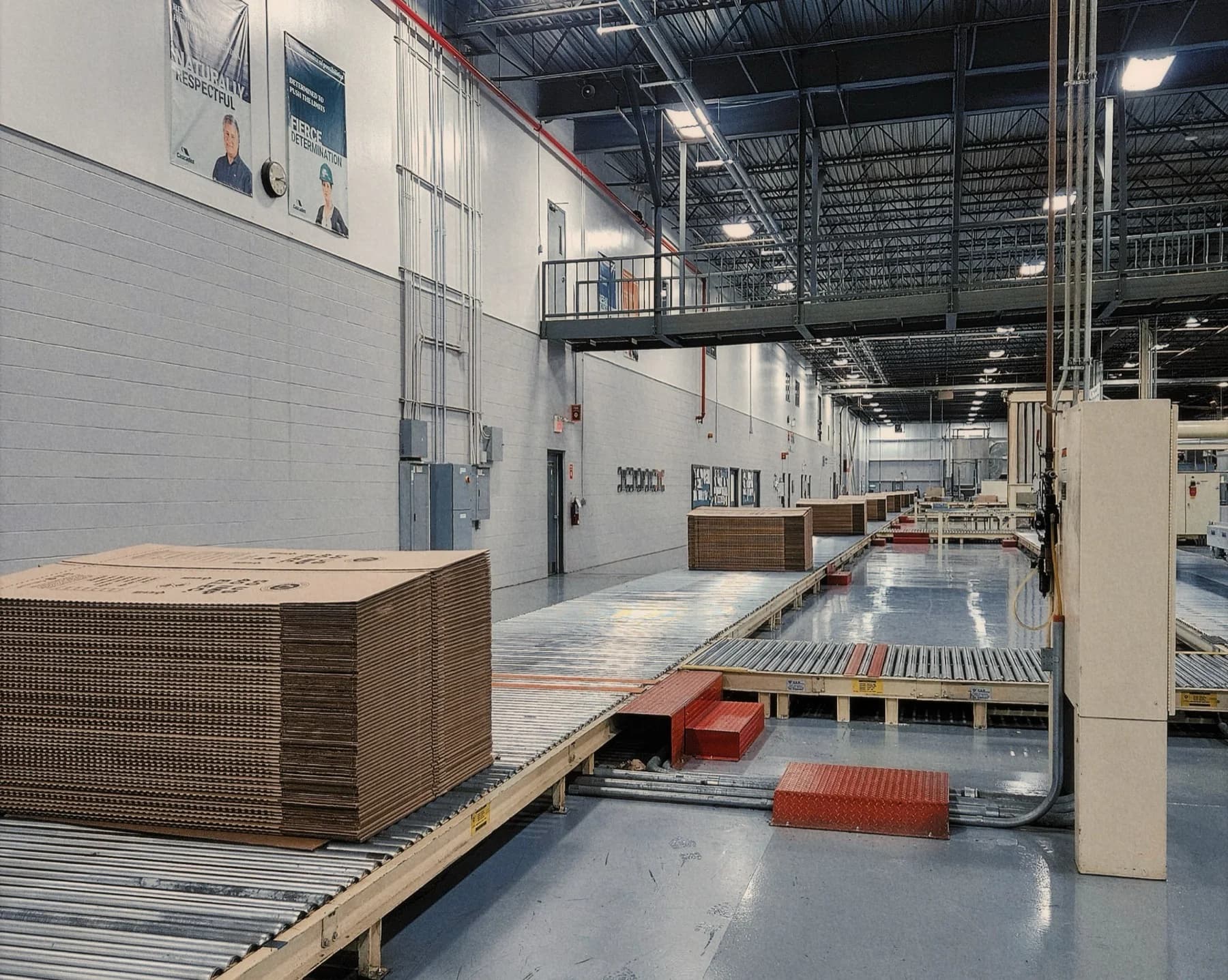 Corrugated board moving down a conveyor in a packaging factory
