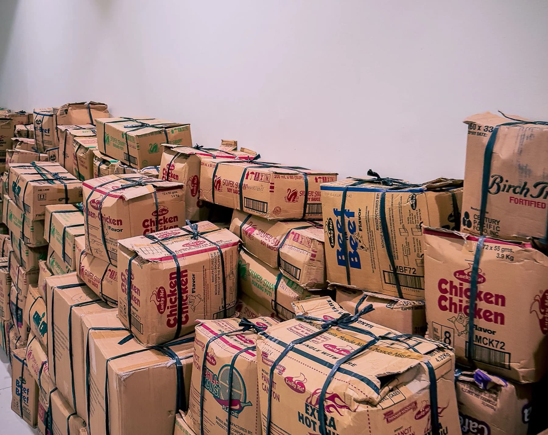 Large stacks of corrugated cardboard boxes in an industrial warehouse