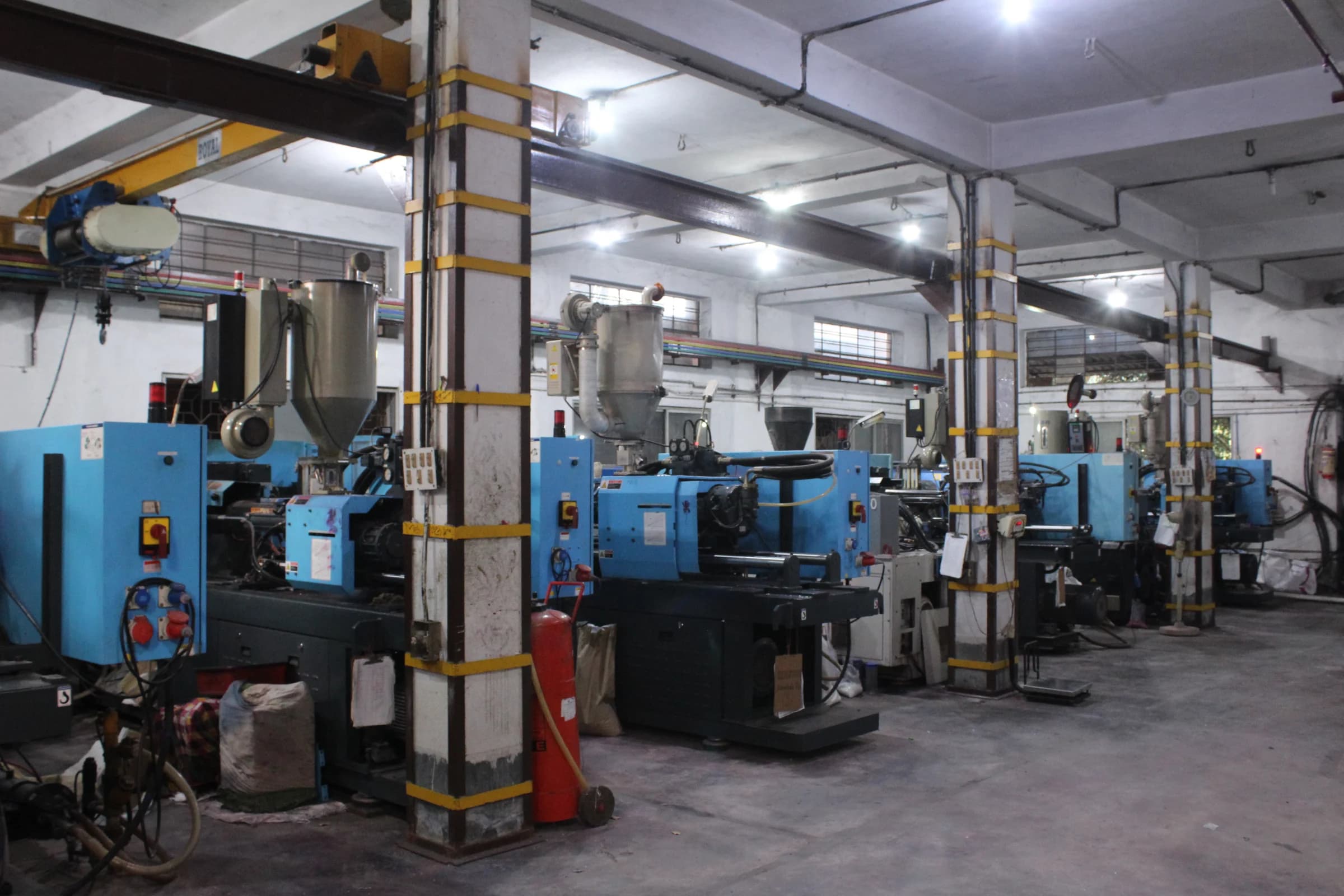 Large plastic injection-moulding production floor with several industrial moulding machines
